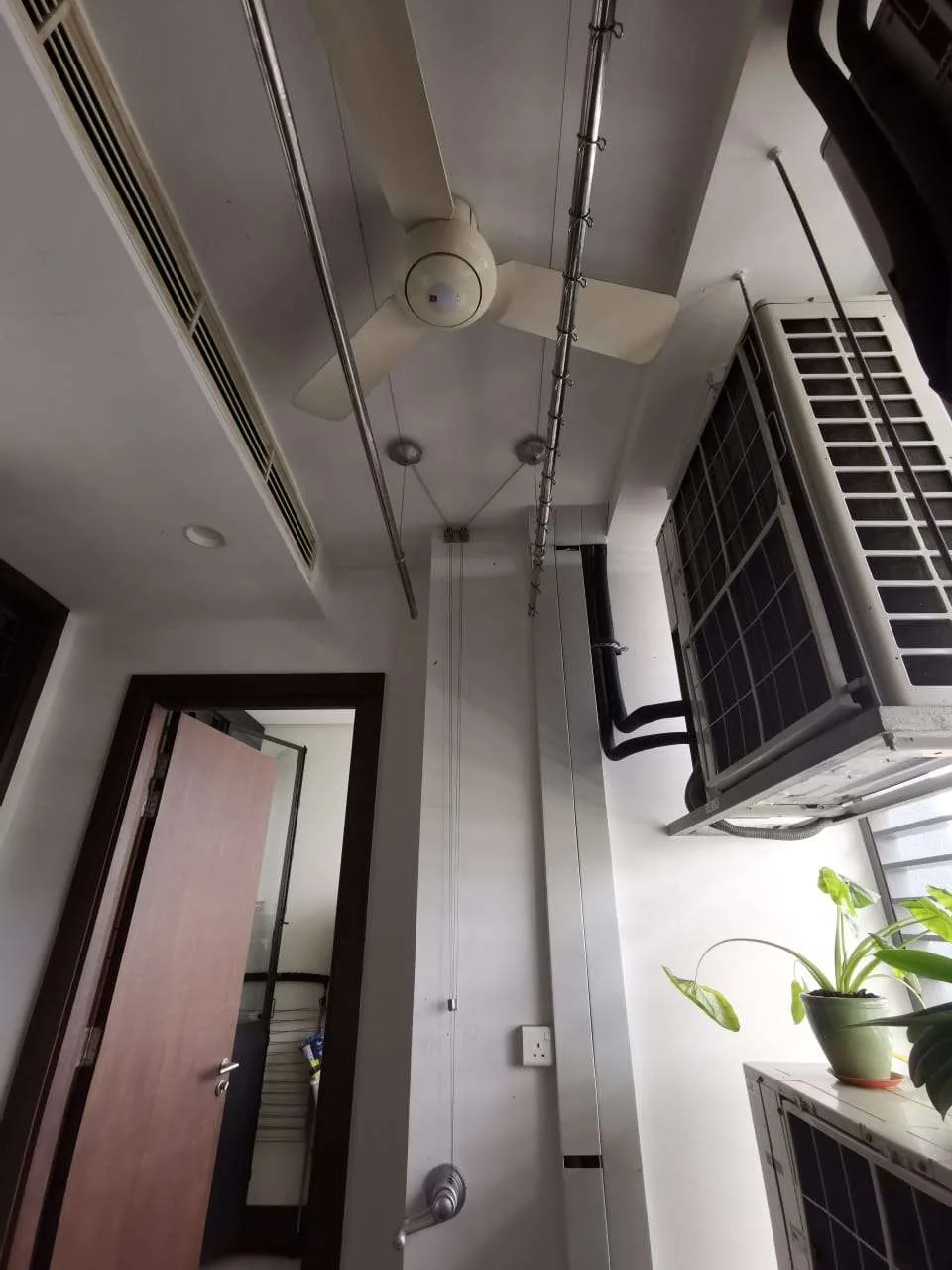 Clothes drying rack installed around a ceiling fan with clearance for the fan blades